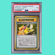A rare Pikachu Illustrator Pokémon card hangs in front of a teal background.